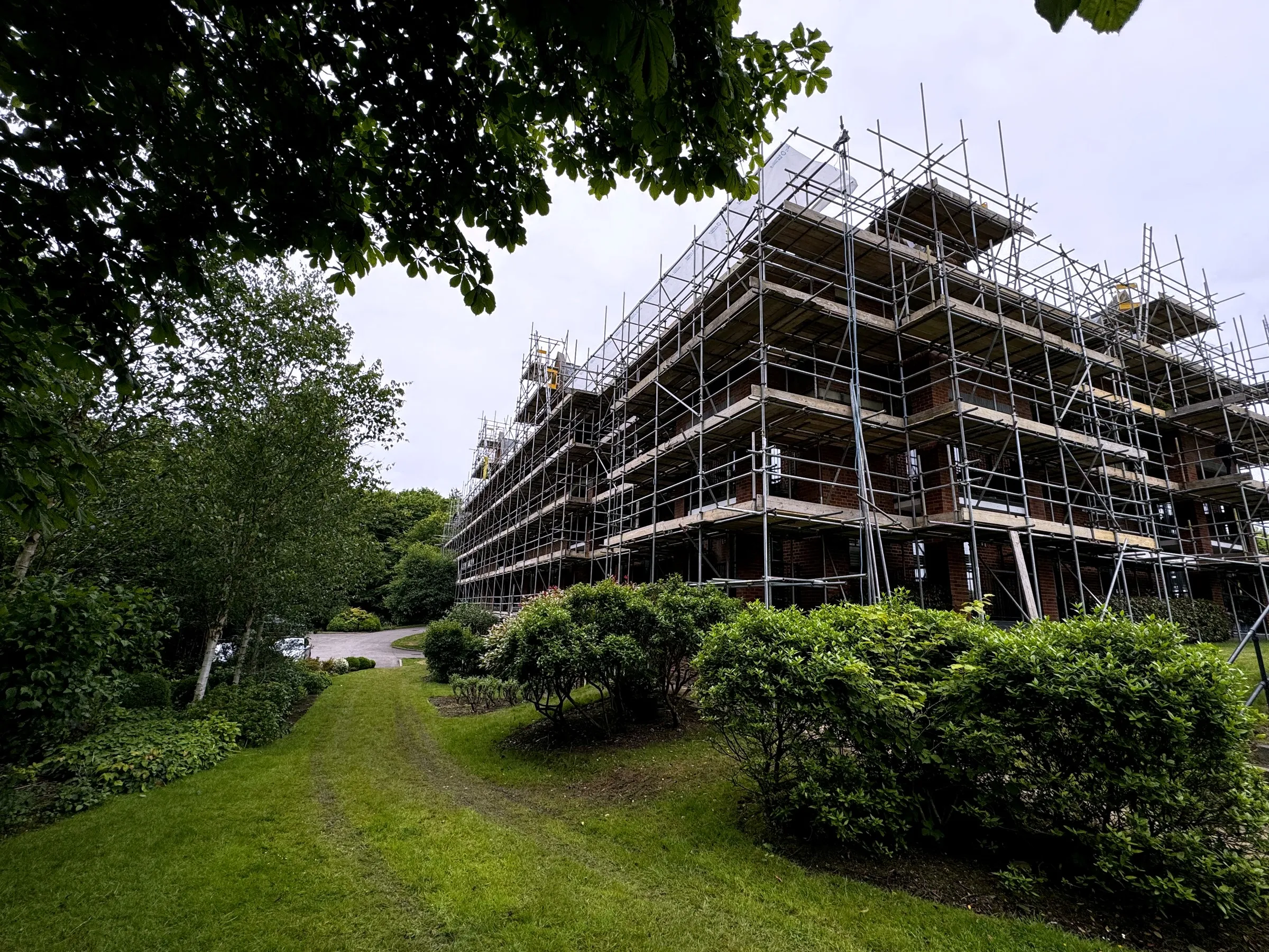 Scaffolding around a large Victorian red-brick building, giving safe access for high-level work